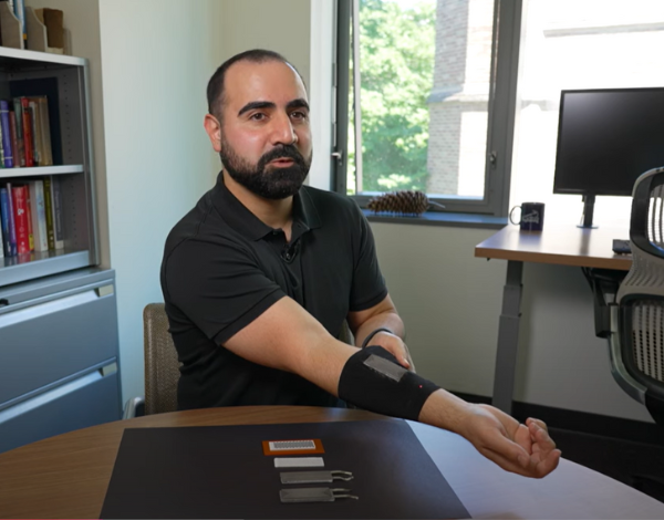 UW researcher Mohammad Malakooti wearing the black sleeve that powers an LED